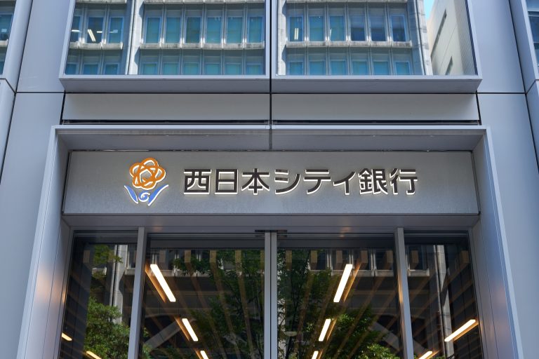 西日本シティ銀行のBeReal投稿による顧客情報流出と私用スマホ全面禁止を伝える報道イメージ